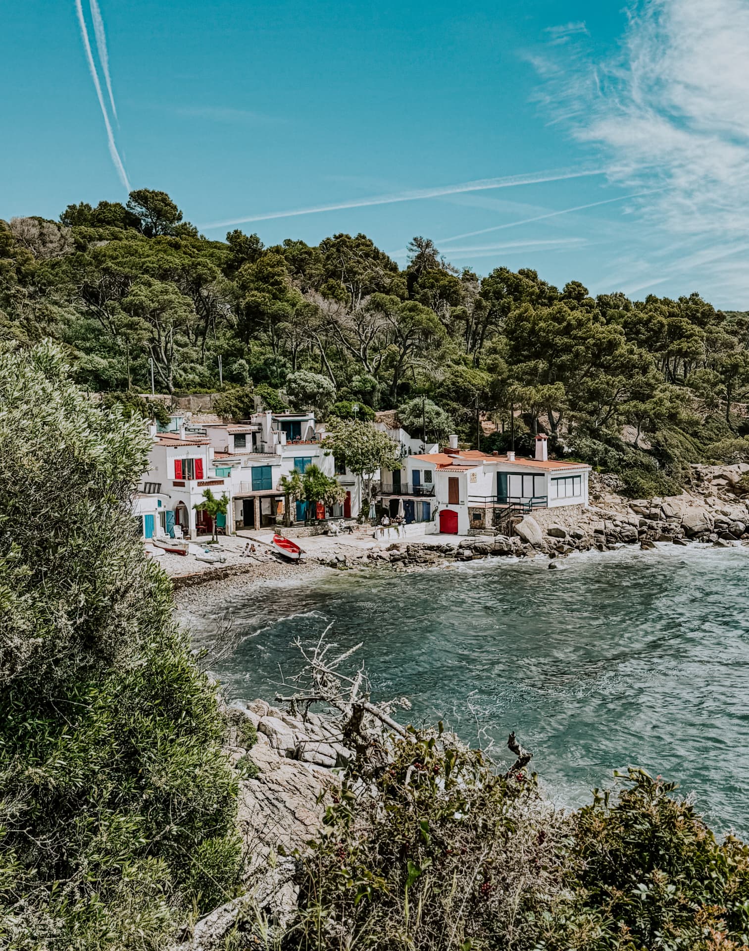 White fishing cottages beside a rocky cove on the Costa Brava